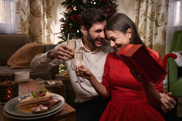 Man and woman holding champagne glasses in their hands