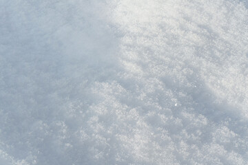Obraz premium Sun shines on ground covered with snow forming small hills - closeup macro detail