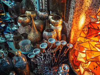 Fototapeta premium Oriental pattern brass candle lamps on display at souk - traditional street market in Morocco, closeup detail
