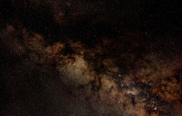 Night sky with milky way near Scutum constellation, purple Omega, Eagle, Lagoon and Trifid nebula visible. Long exposure stacked photo