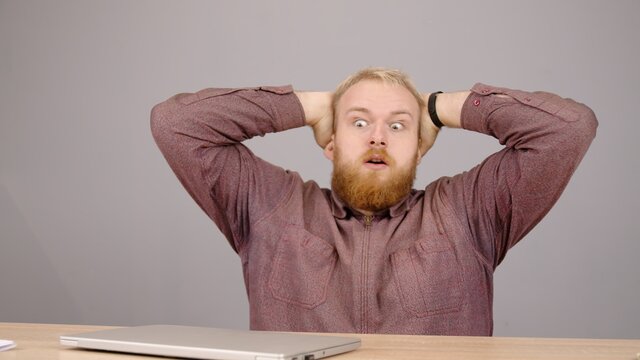 Happy bearded caucasian business man working on laptop from home office. Male executive using computer remote studying, browsing web, having virtual meeting.
