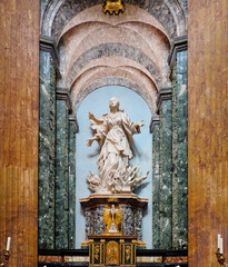 Rome, Italy, June 2017 - view of an altar at Sant'Agnese in Agone and the sculpture of Saint Agnes on the Pyre