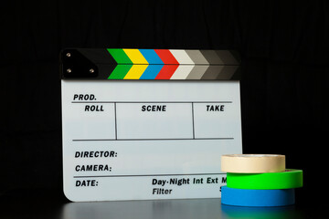 Film clapper board with colored marking tapes in internet content producer dark background studio....