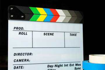 Film clapper board with colored marking tapes in internet content producer dark background studio....