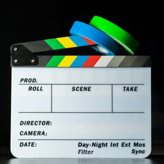 Film clapper board with colored marking tapes in internet content producer dark background studio....