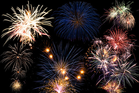 New year celebration fireworks against dark sky. Composition.