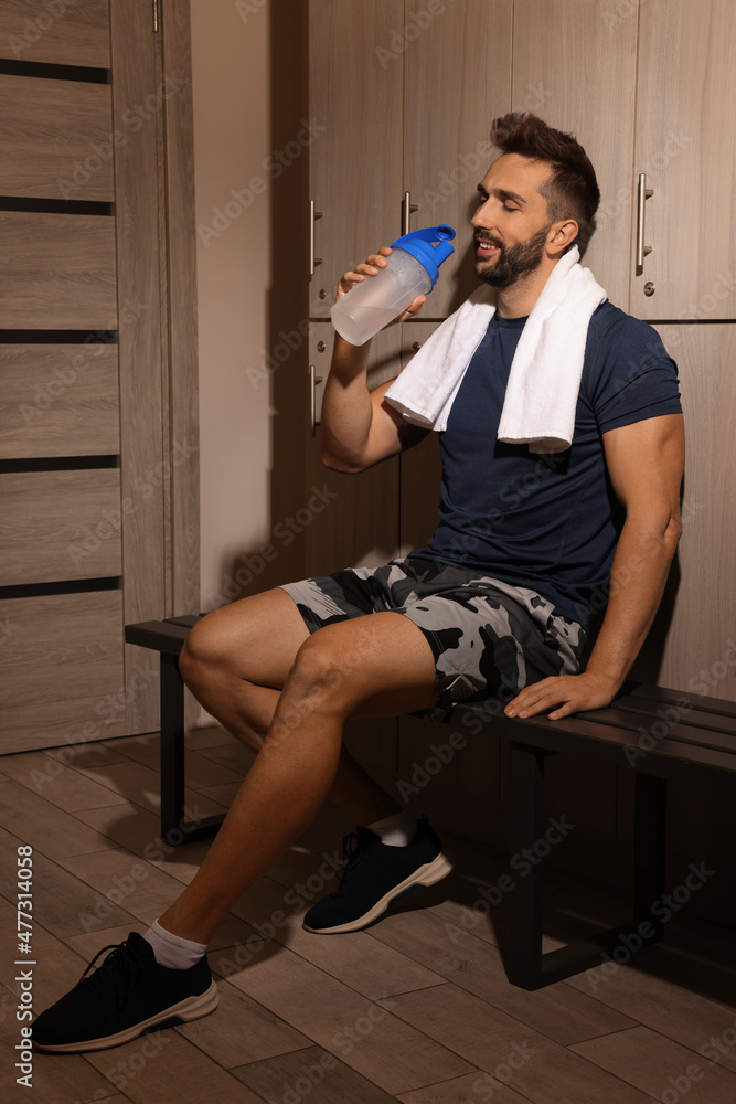 Sticker handsome man drinking water in locker room