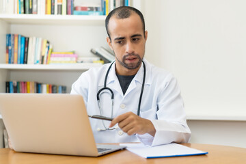 Latin american scientist talking with doctor at video call