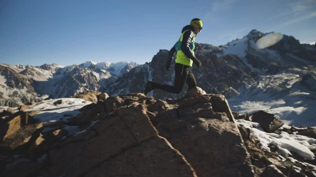 Man running at the mountain with snow