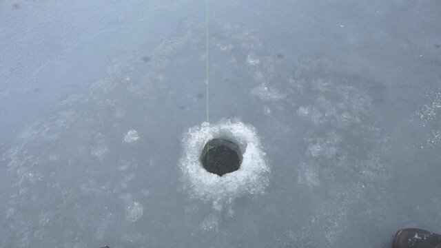 angling in a hole in the ice and a jumping perch, Zealand, Denmark, Januar 27, 2021