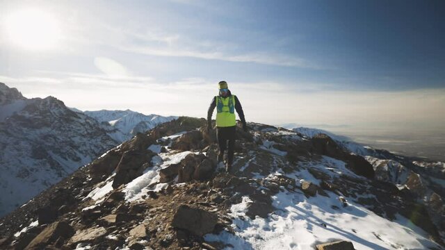 Man running at the mountain with snow