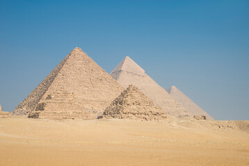 Fototapeta na wymiar Landscape of the pyramids in the desert with blue sky in Giza, Egypt