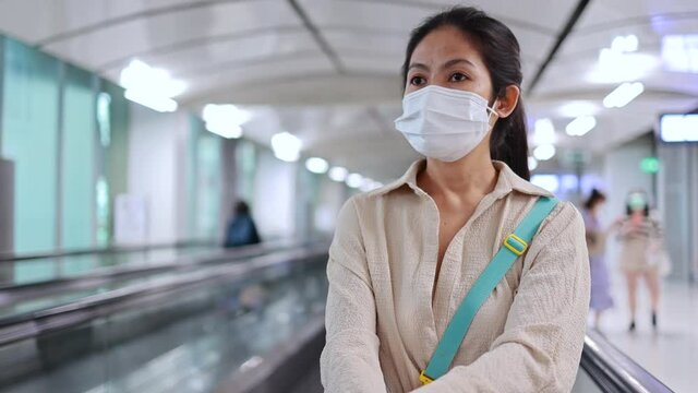 Asian female tourist wear a mask in an airport