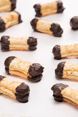 Artisanal almond chocolate biscuits called bokkepootjes on a marble surface