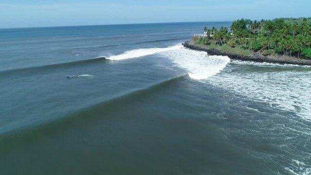 Aerial view of panga going out to the sea, slow motion