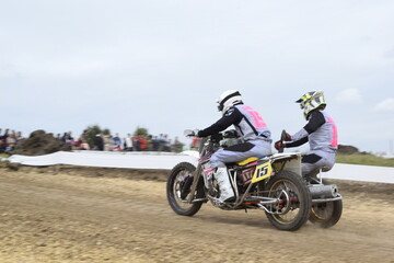 Obraz na płótnie Canvas motocross bikers on motorcycles with carrycot