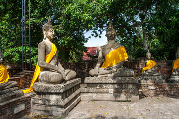 Aligned Sitting Buddha Statues at Wat Yai Chaimongkol in Ayutthaya, the 13 century historic capital...