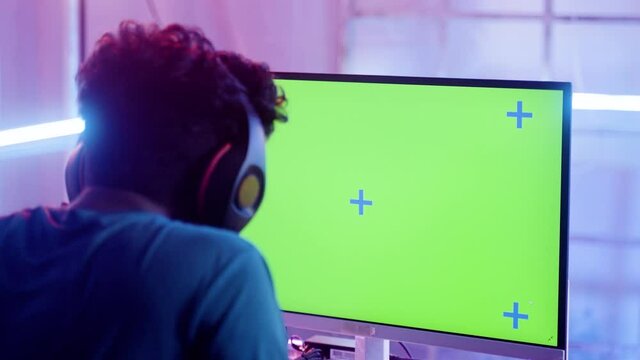 focus on moniter, young professinonal gamer got disappointed due to lost in video game match at champions tournment on green screened mock up - concept of esports, entertainment and live streaming.