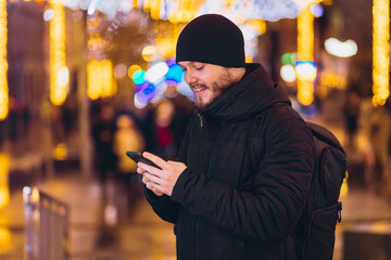 man with the phone. night city. winter. shopping, video communication