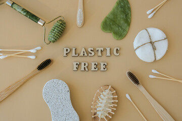 END PLASTIC WASTE text around Natural skin care products on neutral beige background, flat lay....
