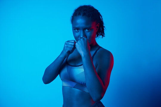 Black woman in fighting stance in studio