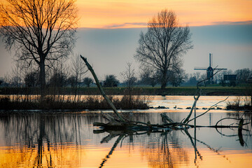 Sunset in dutch river landscape in wintertime.