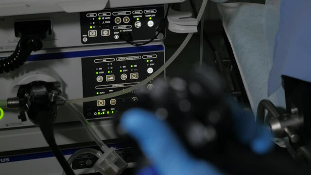 Close-up of doctor gastroenterologist hand with endoscope during diagnostic colonoscopy procedure
