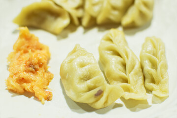 Momo , type of South Asian dumpling; native to Tibet, Nepal, Bhutan and Sikkim. It is similar to Chinese baozi and jiaozi, Mongolian buuz, Japanese gyoza and Korean mandu. Stock photograph.