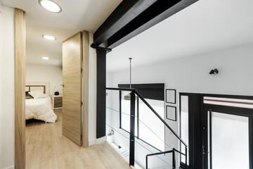 Duplex loft with bedroom on top and metal stairs going down