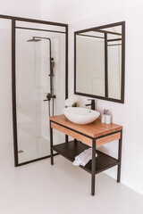 White modern shower room with glass partition and washbasin