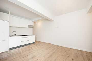 White and cream kitchen in empty apartment