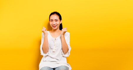 Fototapeta na wymiar Asian teenage girl feeling happy. smiling and looking at the camera in taking pictures of himself yellow studio photography Smile concept, various presentations, free space