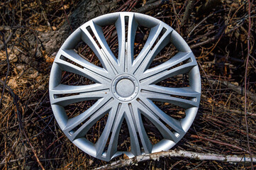 Silver plastic car wheel rim cap. Part of a car wheel. Detail of the vehicle. Tire service....