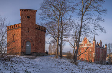 Fototapeta na wymiar Panorama view with brick tower and old officer buildings at the island Skeppsholmen a snowy winter day in Stockholm