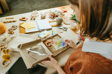 Young woman packing purchase for the buyer at eco friendly package