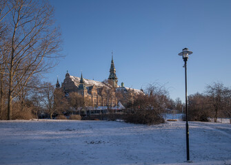 Snowy view with a gothic museum building on the island Djurg&aring;rden a sunny winter day in Stockholm