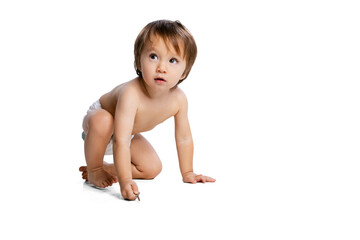 Portrait of little boy, baby, child in diaper posing isolated over white studio background. Childhood concept