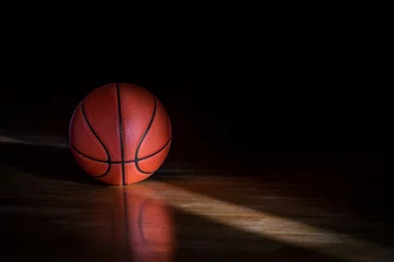 Foto op Plexiglas Basketball on hardwood court floor with natural lighting. Workout online concept. Horizontal sport theme poster, greeting cards, headers, website and app © Augustas Cetkauskas