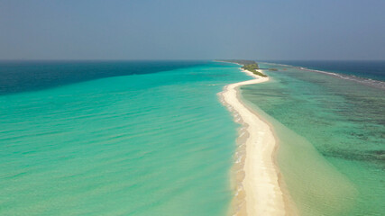 Aerial view of a tropical island with a sandbank, surrounded by turquoise water. Dhigurah island, Maldives.