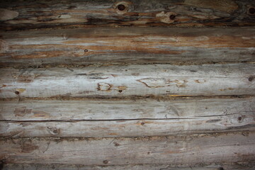 Obraz premium Old weathered horizontal wall log cabin of a village shed rural background texture