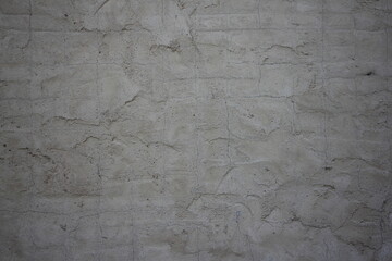 Gray dry plastered cracked concrete wall close-up texture of industrial background
