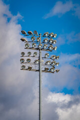 Stadium Field Lights Under Clouds and Blue Sky