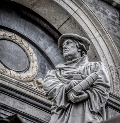 Monument of the reformer Martin Luther with a bible in his hand in front of Marble church  in...