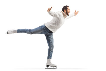 Full length profile shot of a man in jeans and white knitwear performing ice skating