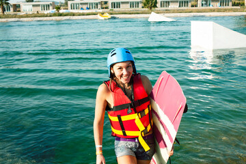 young smiling girl on wake board in water, happy lifestyle people on vacations