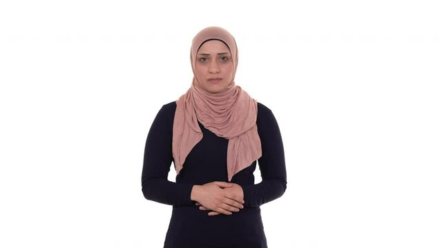 Portrait of a serious muslim woman with a warning finger gesture. Isolated on a white background.