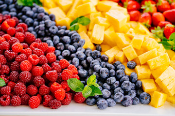 fruit assorted. raspberries, blueberries, pineapple and strawberries