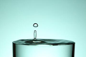 splash of water, bright blue background