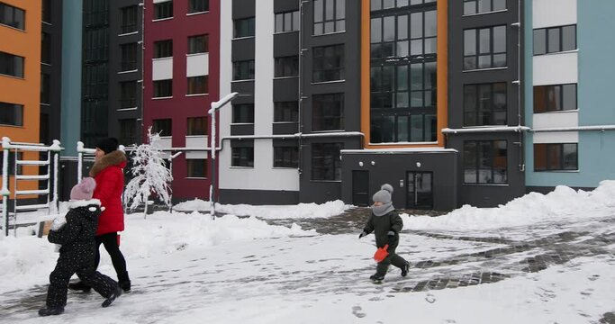 children play with snow on the playground