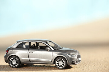 Fototapeta na wymiar Miniature car model outdoors on sunny day. Space for text